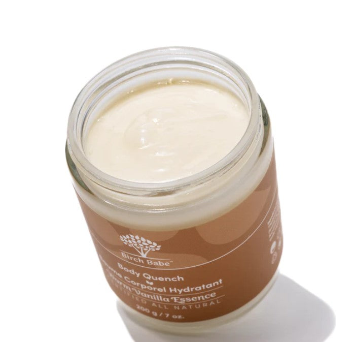 Close-up of the Body Quench bottle featuring warm vanilla scent label and textured lotion cap for easy dispensing.