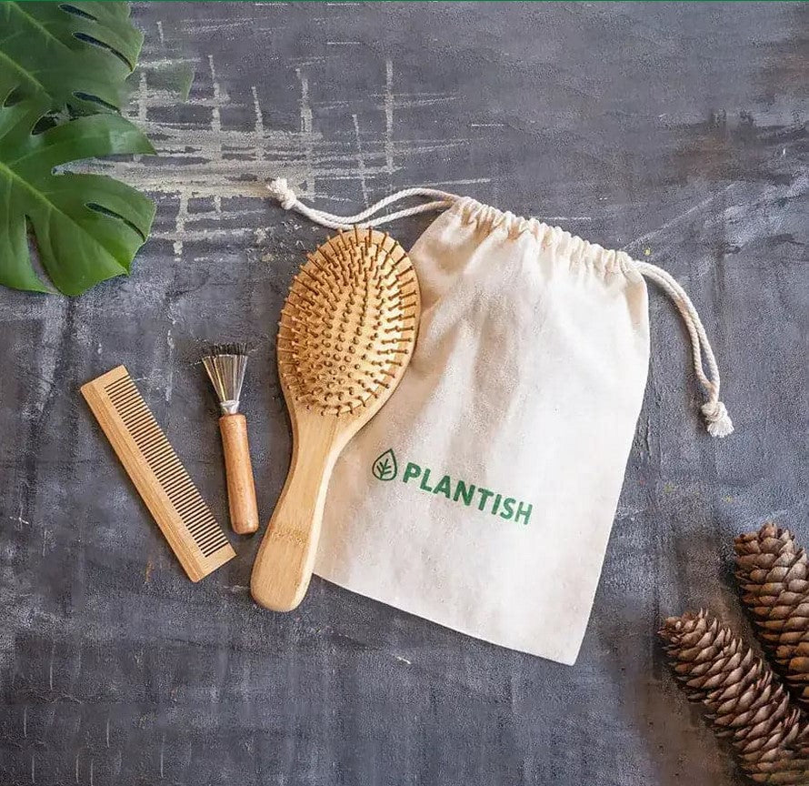 Close-up of the bamboo hair brush's textured handle showcasing smooth, natural wood grain and ergonomic design for