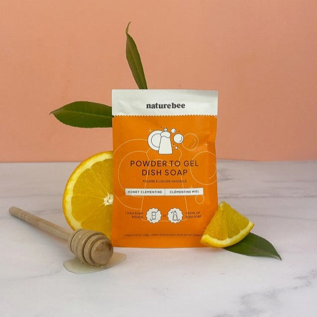 Clear plastic pouch displaying colorful fruit-scented dish soap gels with measuring indicators on the side