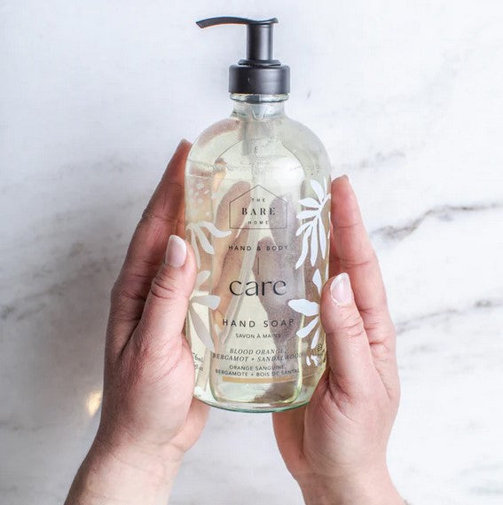 Close-up of the hand soap’s textured amber bottle cap and embossed floral detailing, highlighting the luxurious finish.