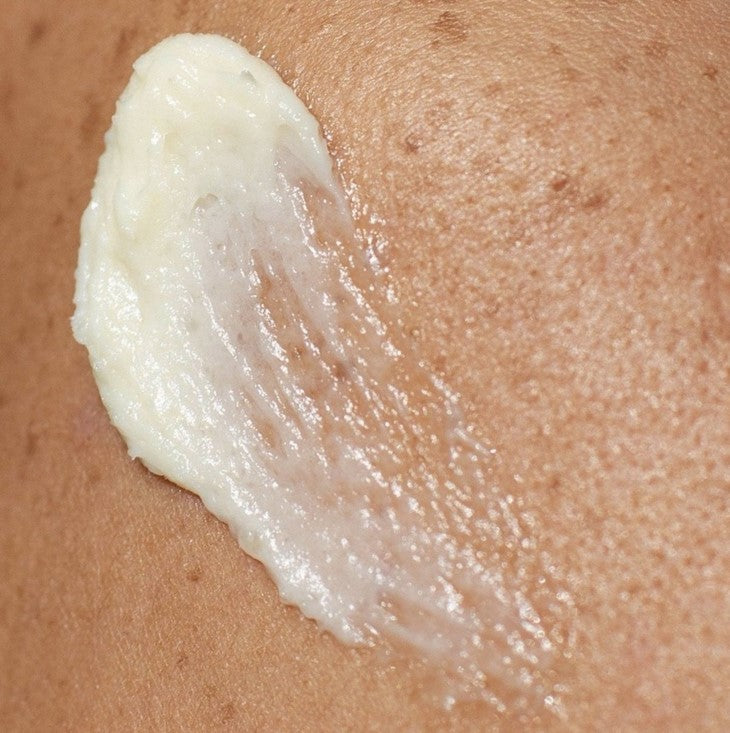 Close-up of Rejuvenating Face Cream jar showing textured surface and delicate floral scent notes on the label