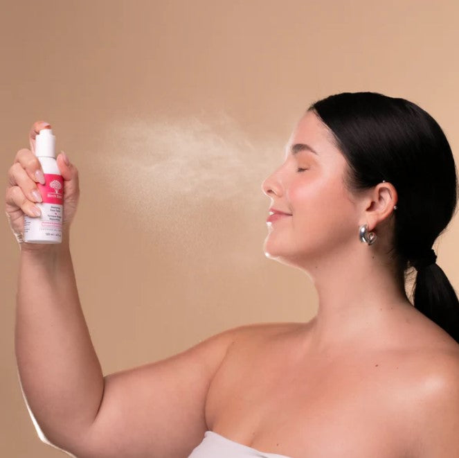 Close-up of Restoring Face Toner's clear glass bottle showing refreshing scent notes and textured label detail