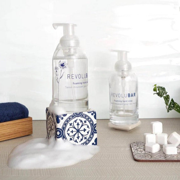 Revolubar Foaming Hand Soap Duo in clear glass bottles with white foaming pump tops, refillable design, Canadian-made