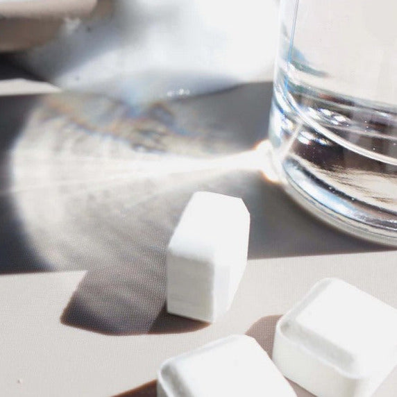 Close-up of the Revolubar Foaming Hand Soap Tablets package showing vibrant label details and compact size on a countertop.