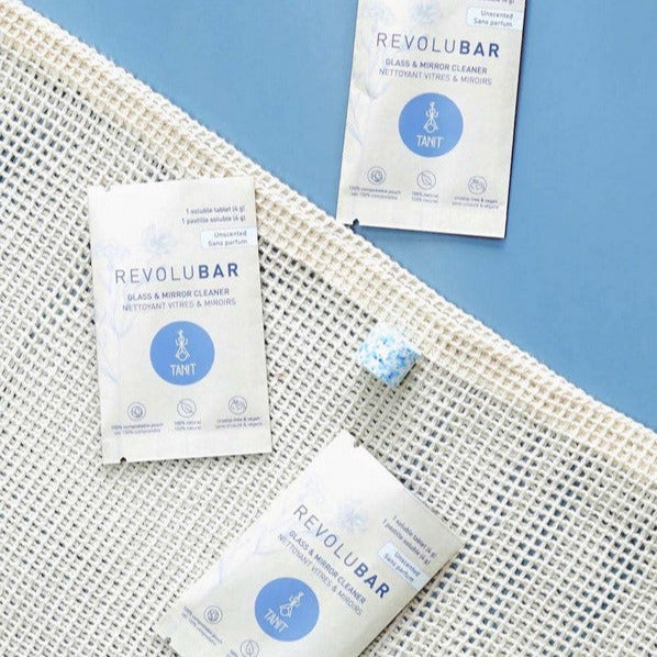 Close-up of the Revolubar tablet showing textured surface and partial label detail on packaging