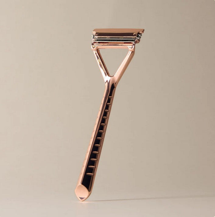 Close-up of rose gold foil accents and textured surface on the Leaf Face and Body Set kit box, showcasing intricate design