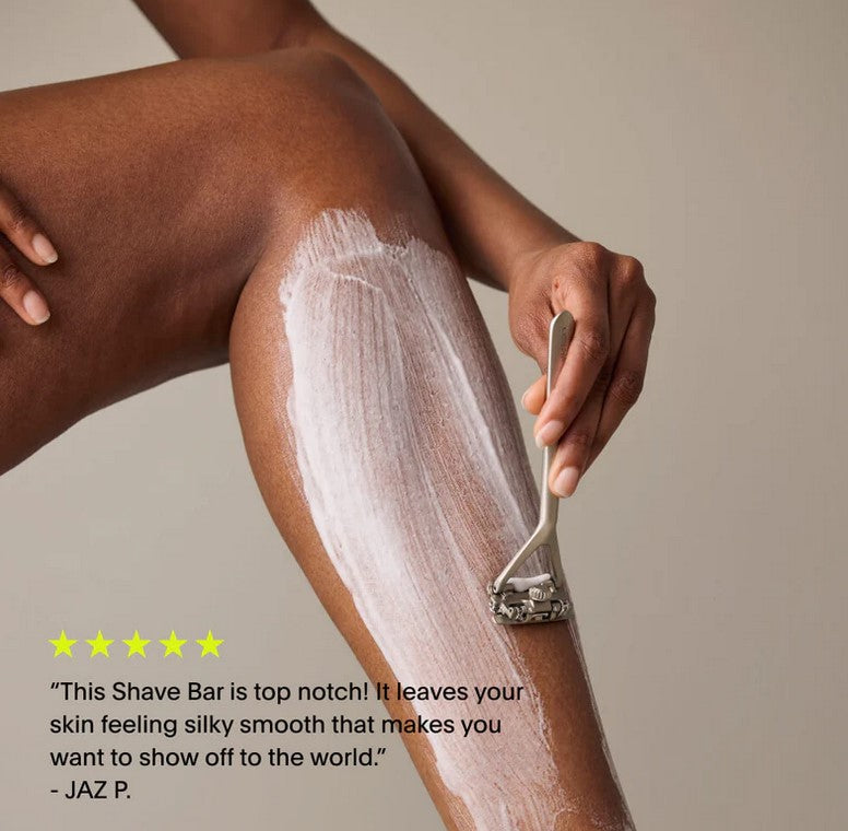 Close-up of a leaf-shaped shaving soap bar’s textured surface with subtle green and cream marbling, highlighting natural