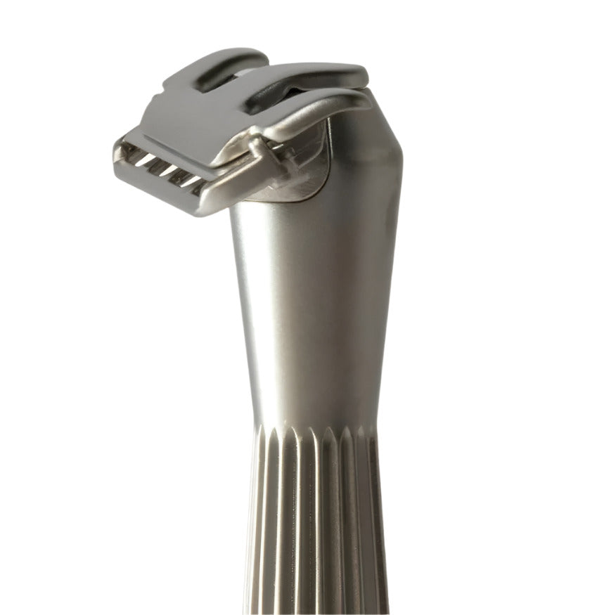 Close-up of the Thorn Razor's textured silver handle tip with engraved branding detail, showcasing precise craftsmanship.