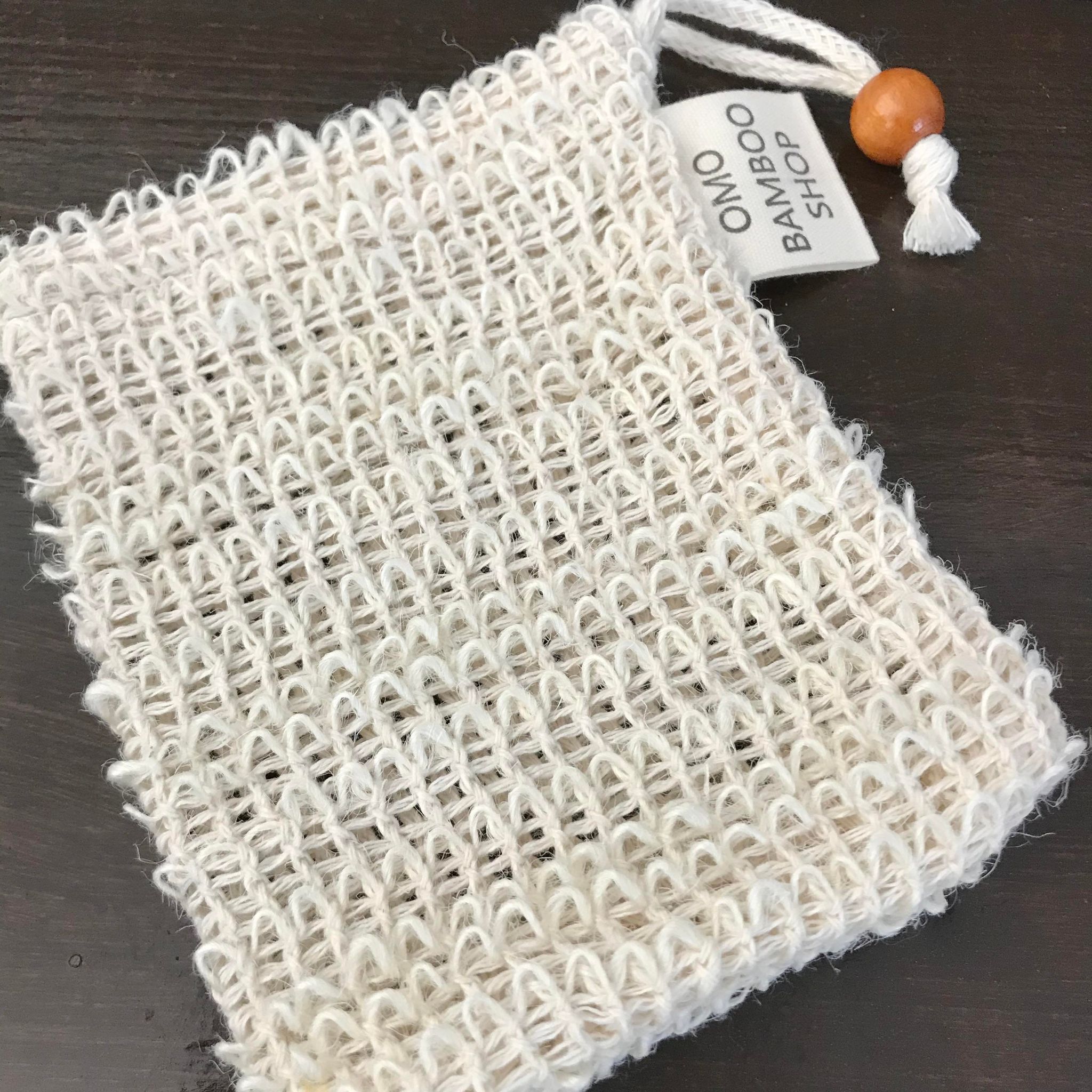 Close-up of the sisal soap pouch's textured fibers and reinforced seam detail from a slightly angled top view