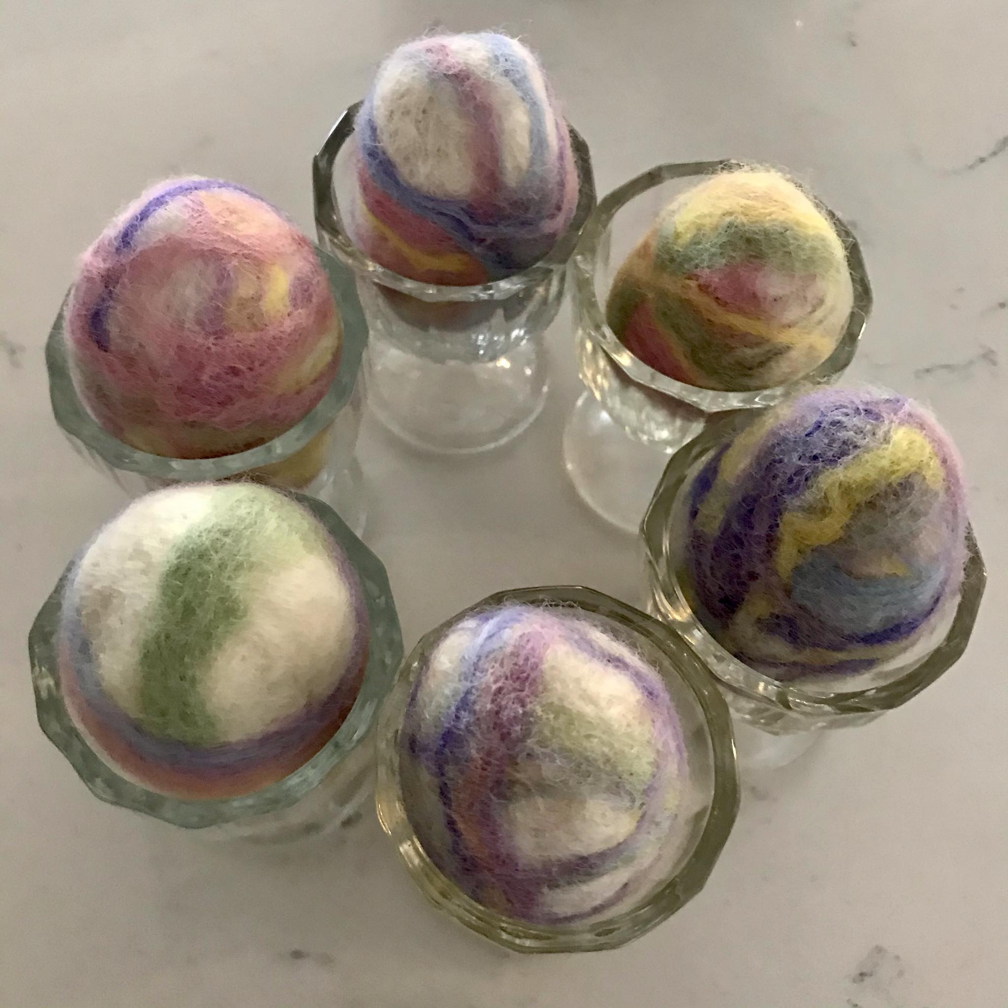 Close-up of the felted soap’s textured surface with embedded colorful Easter egg wool fibers, highlighting intricate