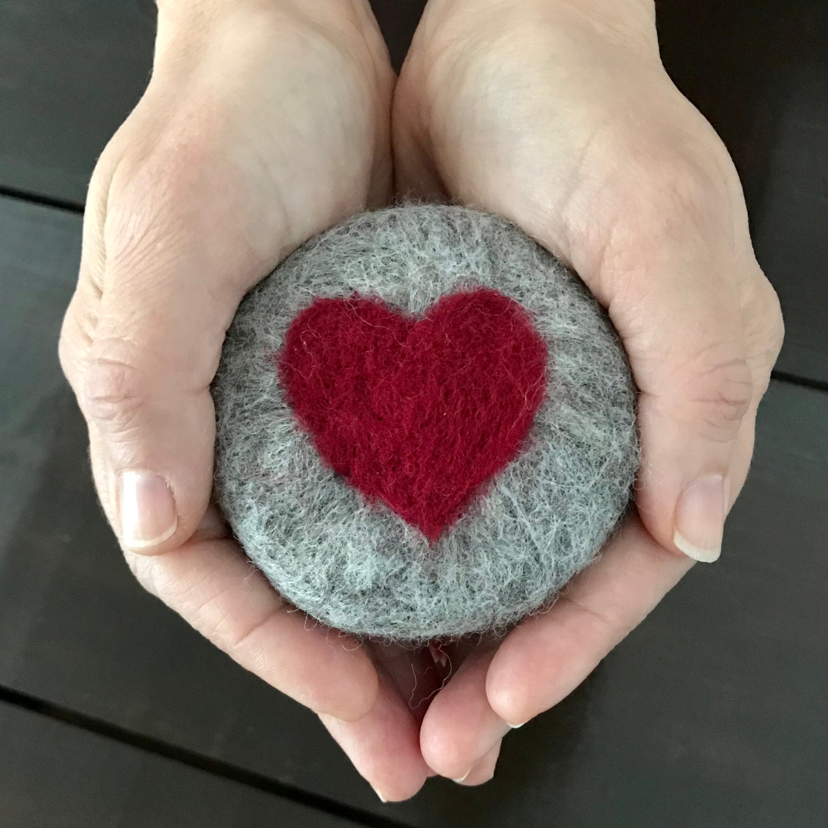 Close-up of felted soap’s textured surface highlighting intricate wool fibers and vibrant color details from a top-down