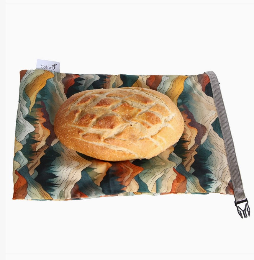 Mountains reusable bread bag with homemade sourdough loaf on top