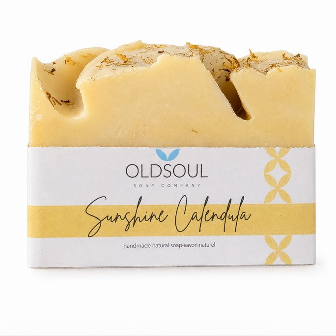 Natural citrus artisan soap with sweet orange and calendula flowers on a white background