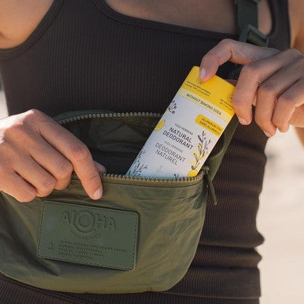 Canadian made Tanit Yuzu Verbena natural deodorant carried in a belt bag for an active lifestyle