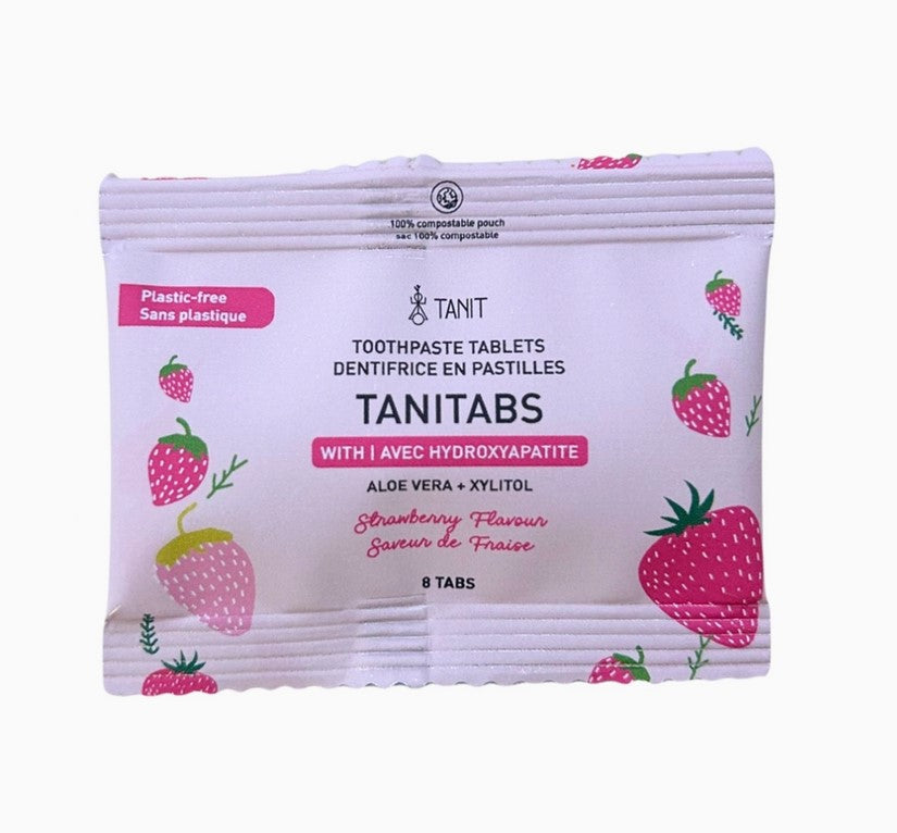 Close-up of the TANITABS Strawberry Toothpaste Tablets container lid revealing textured embossed logo and vibrant pink