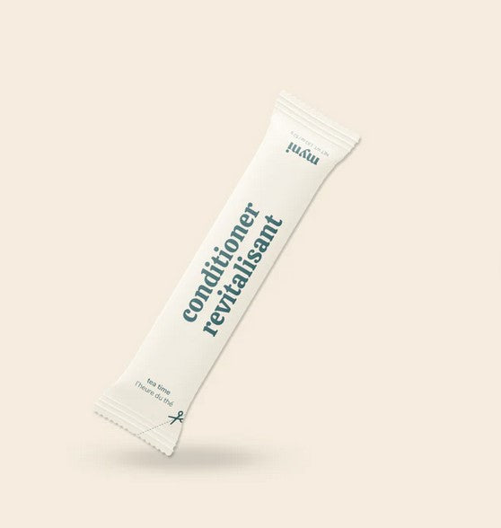 Close-up of Myni Conditioner label highlighting handcrafted, farm-raised ingredients on eco-friendly packaging.