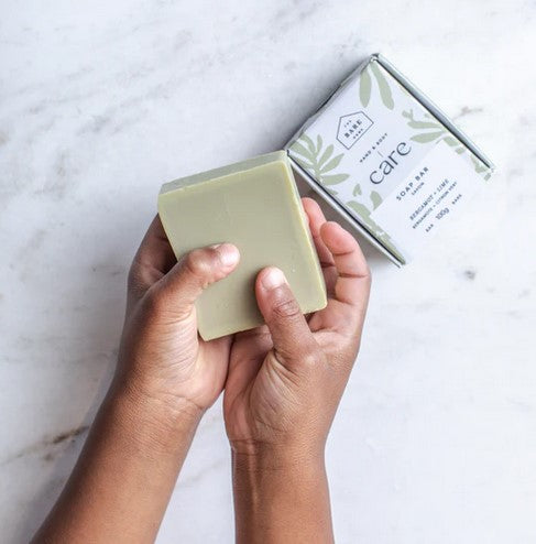 Close-up of the Bergamot Lime Soap bar’s textured surface and embossed logo detail with visible natural fibers and citrus