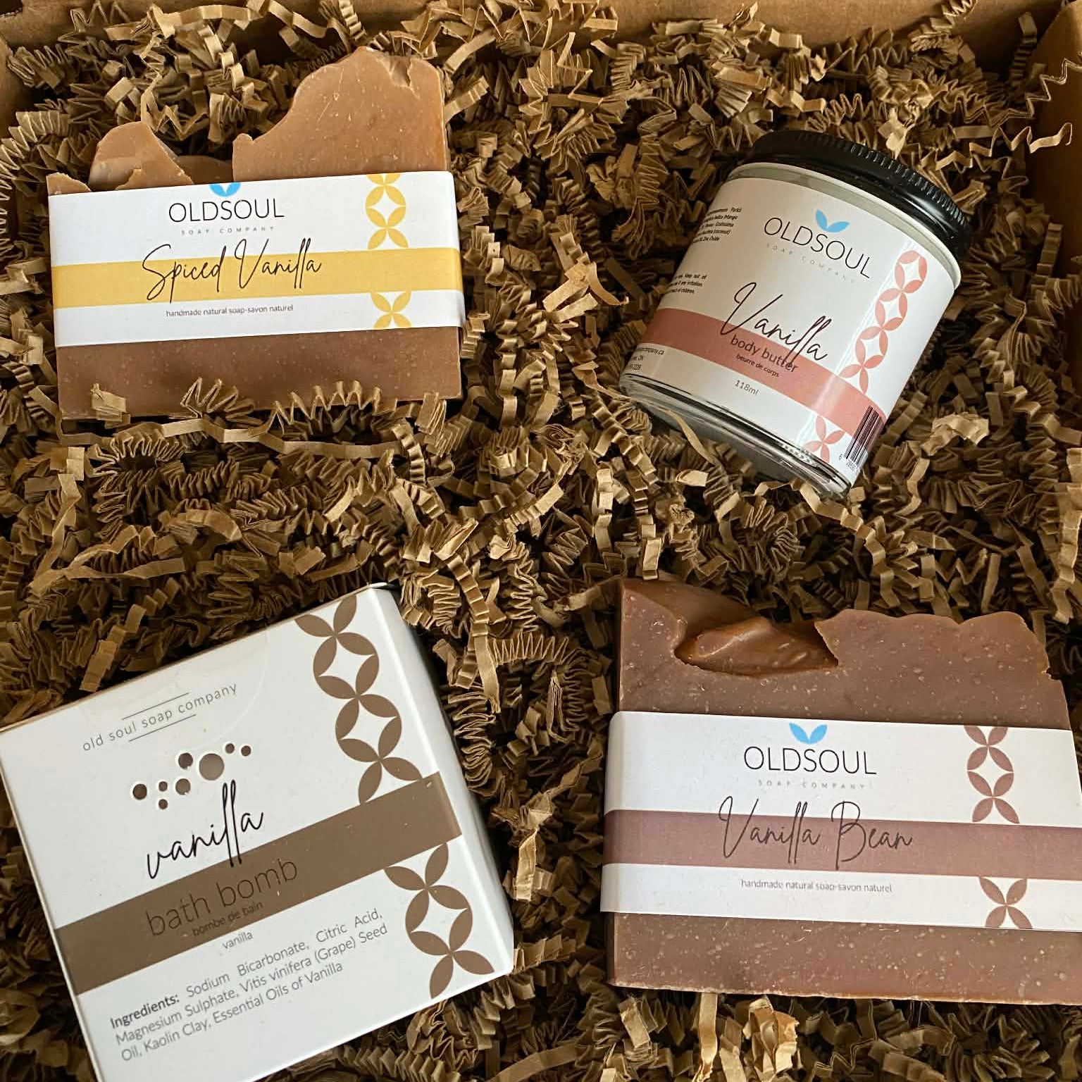 Vanilla Gift Set Deluxe featuring Spiced Vanilla soap, Vanilla Bean soap, vanilla bath bomb, and vanilla body butter from the Old Soul Soap Company in eco-friendly gift box.