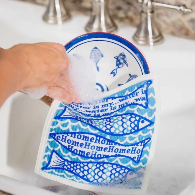 Close-up of the textured, woven surface and vibrant blue color of the Water is My Home Wet It Cloth from a top-down