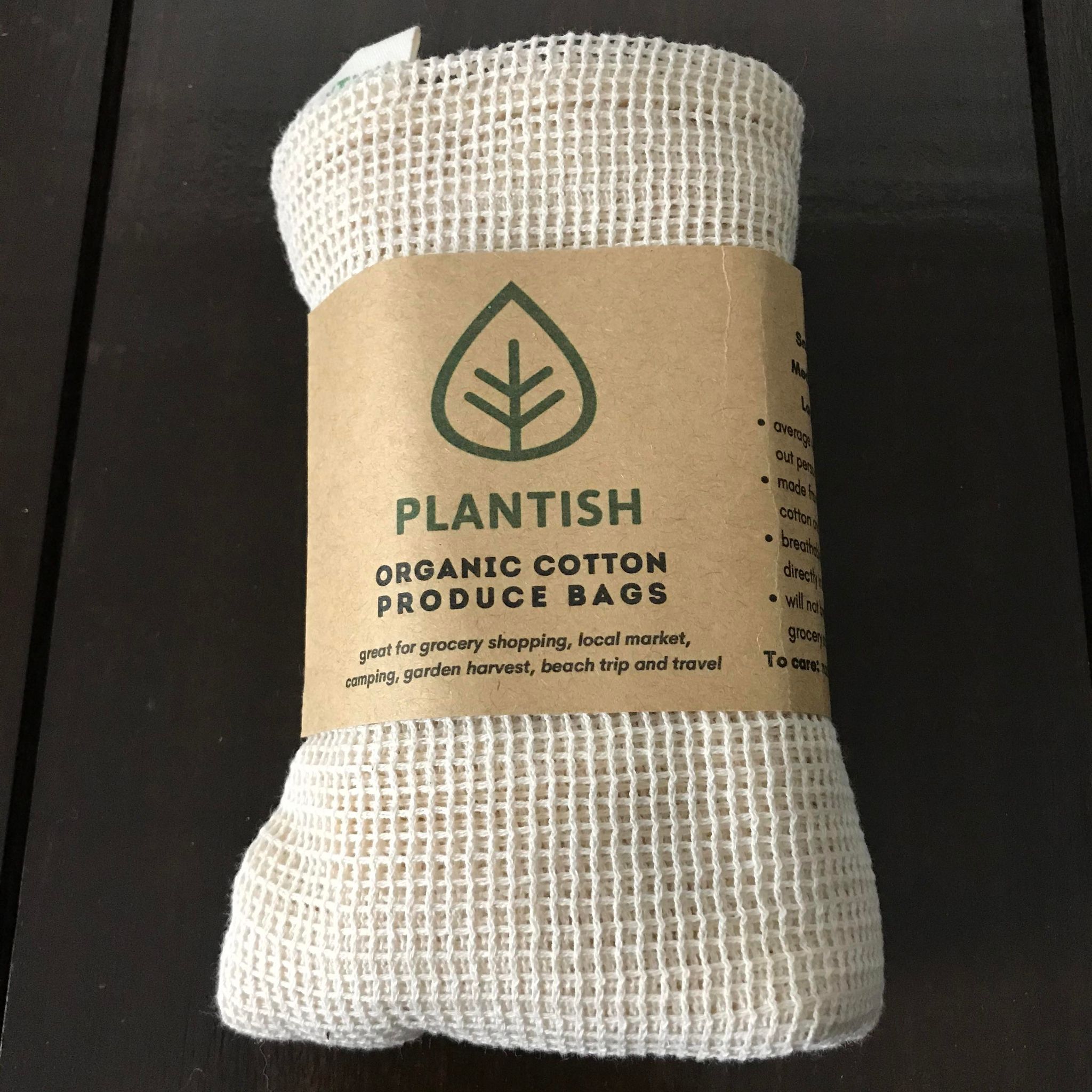 Close-up of colorful fabric drawstrings and reinforced seam detail on organic cotton produce bag center opening