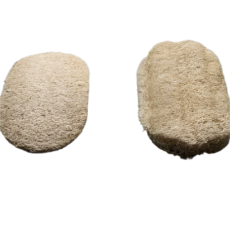 Close-up of the textured, natural loofah fibers showing rough surface and porous structure for effective dishwashing.