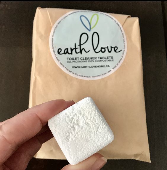 Close-up of Earth Love Toilet Cleaner Tablets showing textured surface and eco-friendly label design