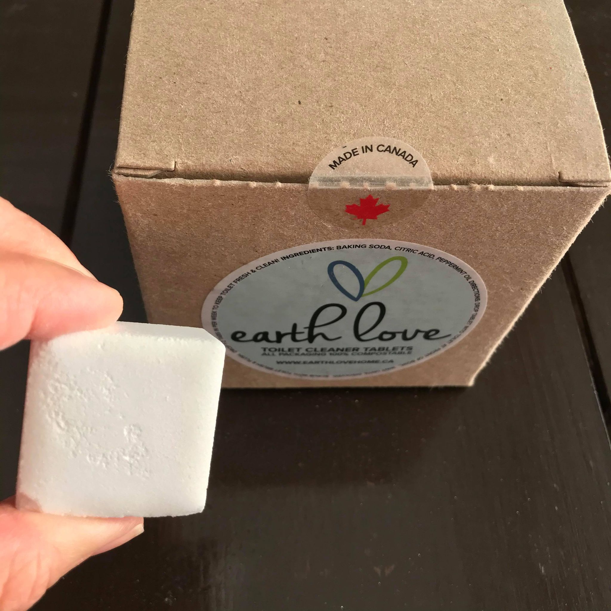 Close-up of Earth Love Toilet Cleaner Tablets packaging highlighting eco-friendly label and natural ingredients on textured