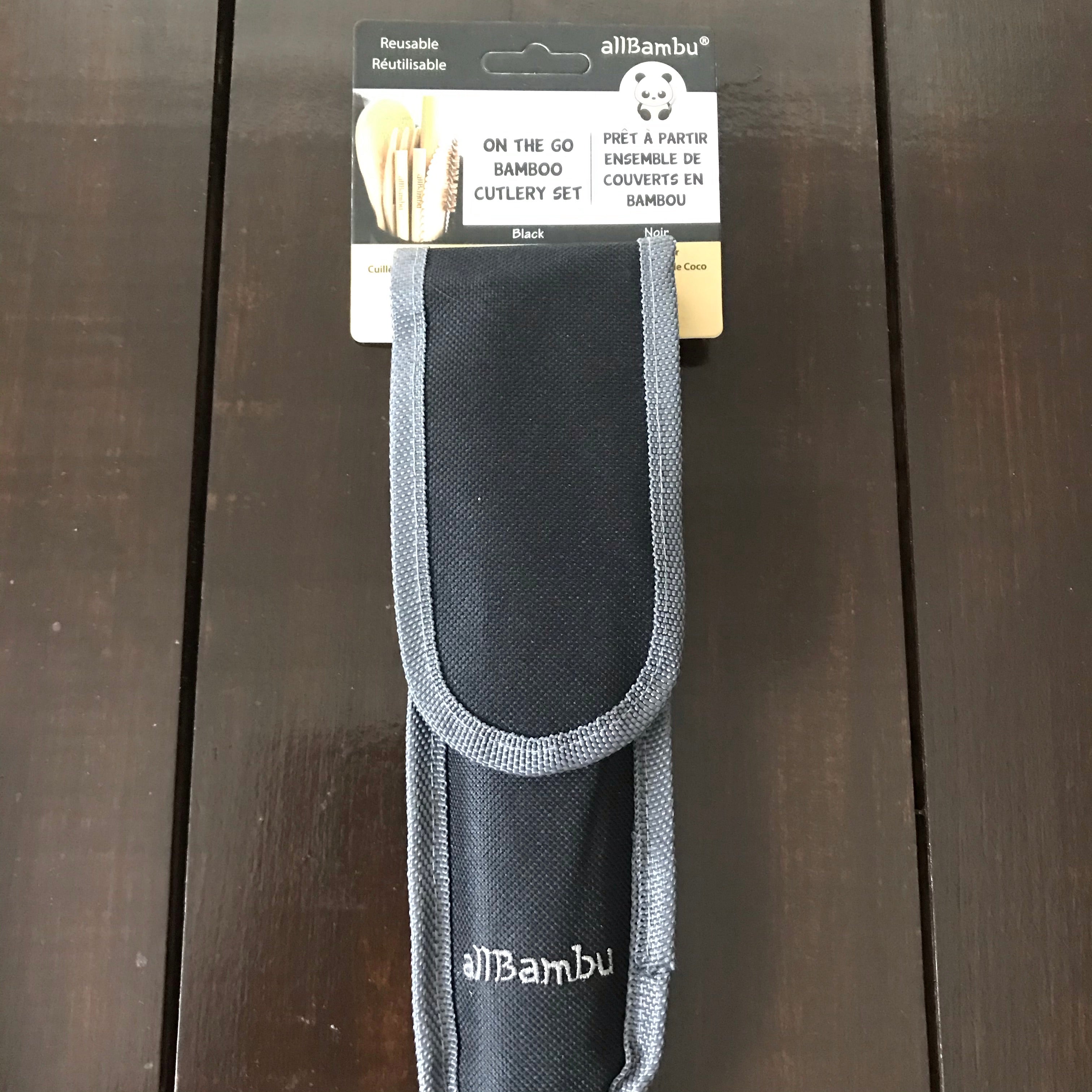 Close-up of bamboo fork and knife with smooth finish and engraved logo, showcasing eco-friendly material and craftsmanship