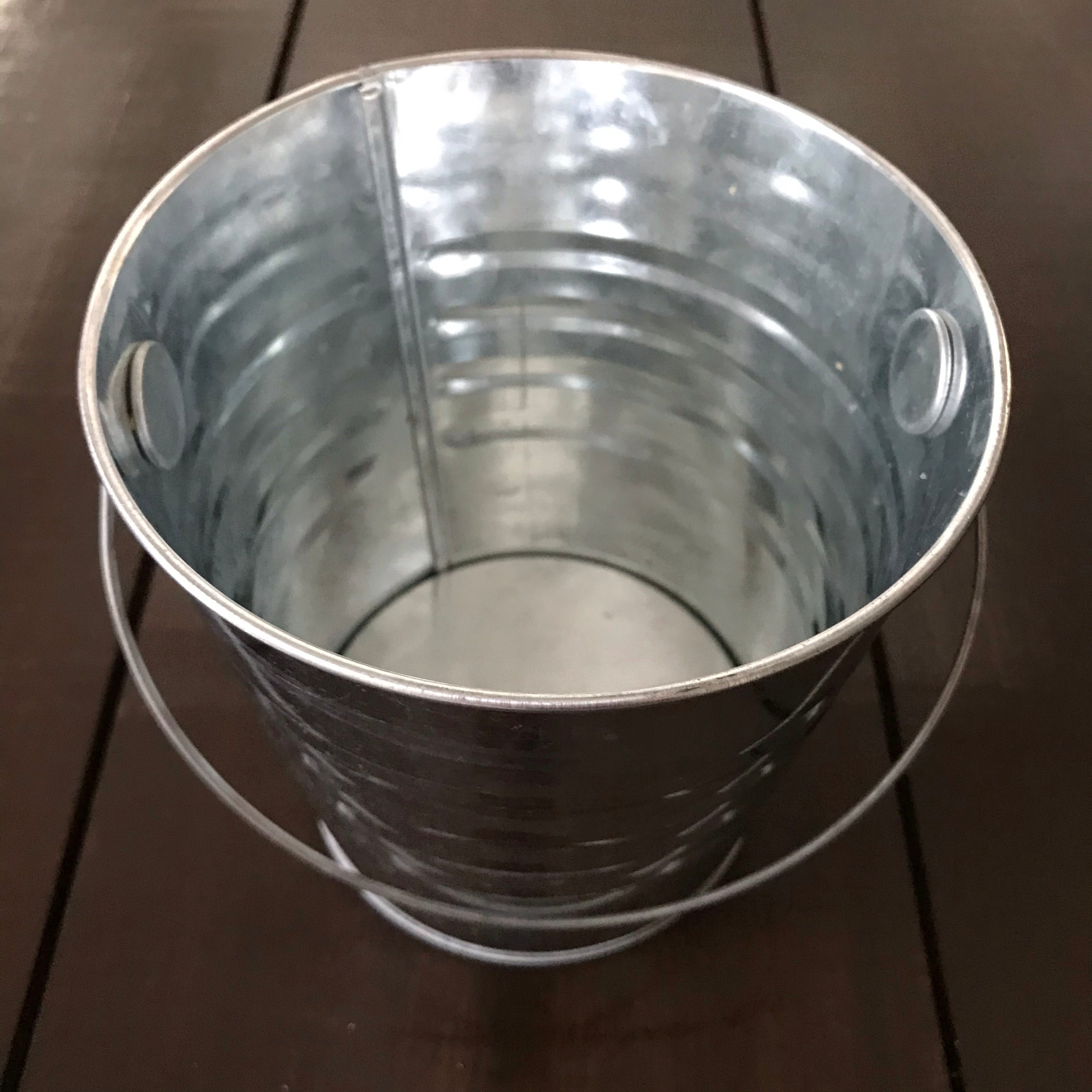 Close-up of hand-stitched water balloon with colorful crocheted yarn and textured surface, ready for outdoor summer play