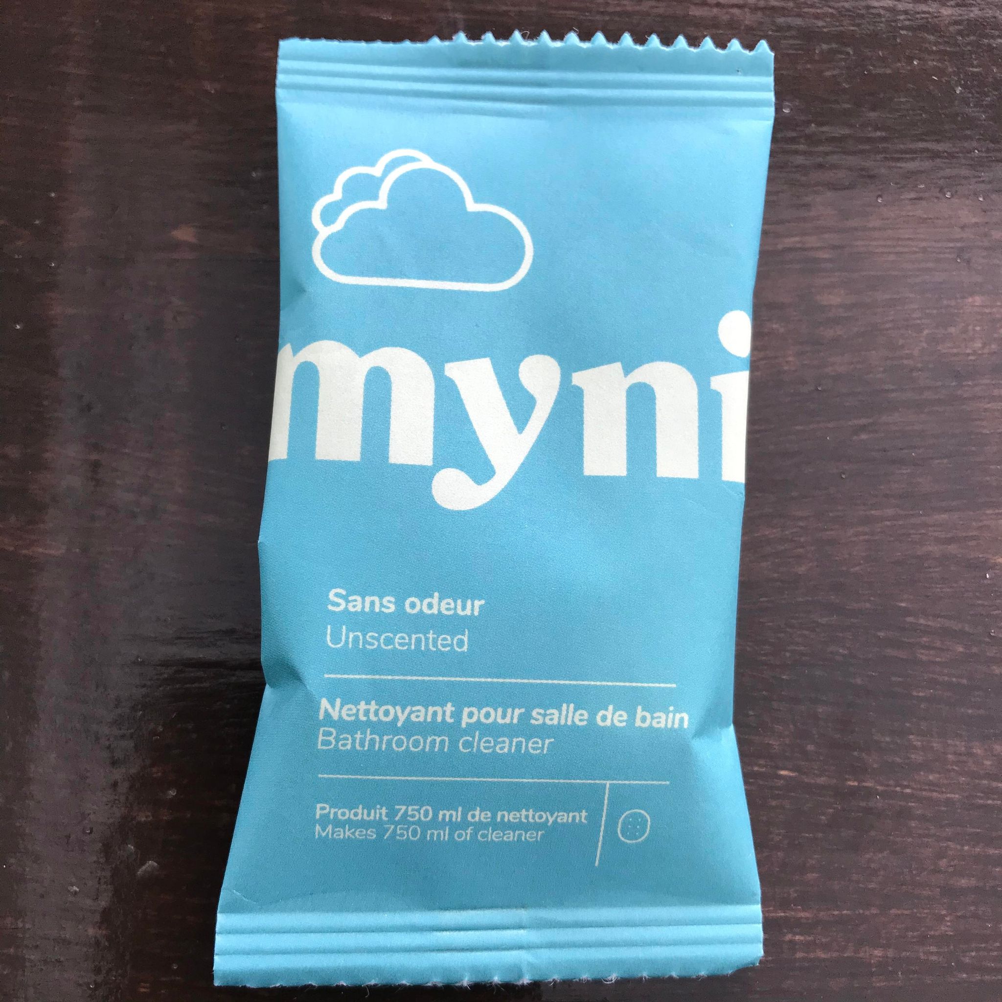 Close-up of Myni Bathroom Cleaning Tablets packaging showing vibrant label detail and compact individual tablet container