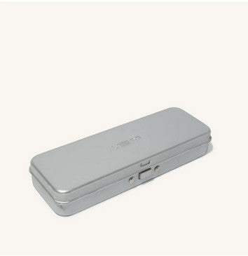 Close-up of The Leaf Travel Case's textured, embossed metal surface with subtle leaf pattern and polished edges, showcasing