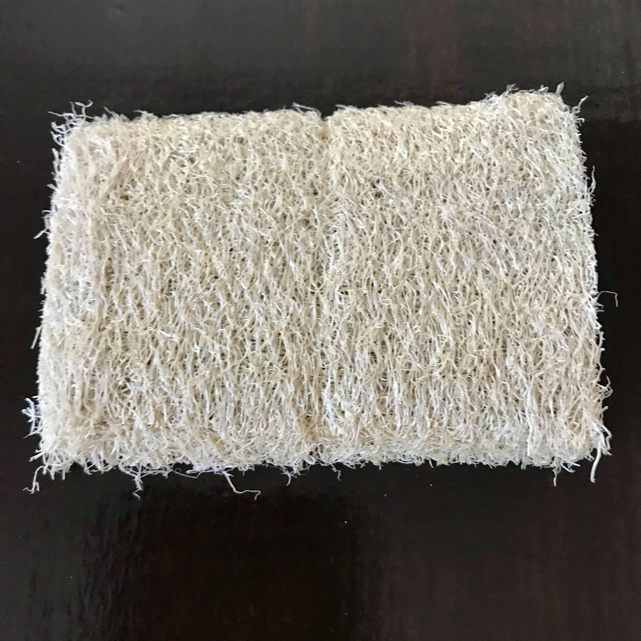 Close-up of textured loofah fibers highlighting natural rough surface for exfoliation in bathroom use