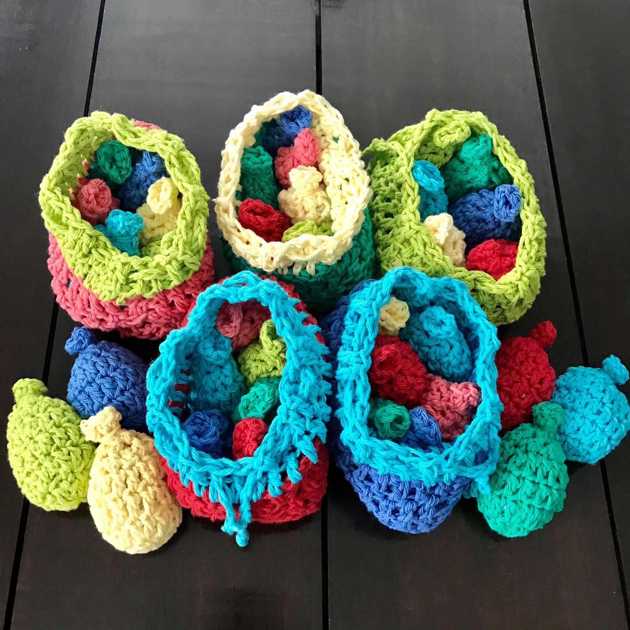 Close-up of hand-stitched crocheted water balloons featuring bright multicolored yarn and textured surface for fun outdoor