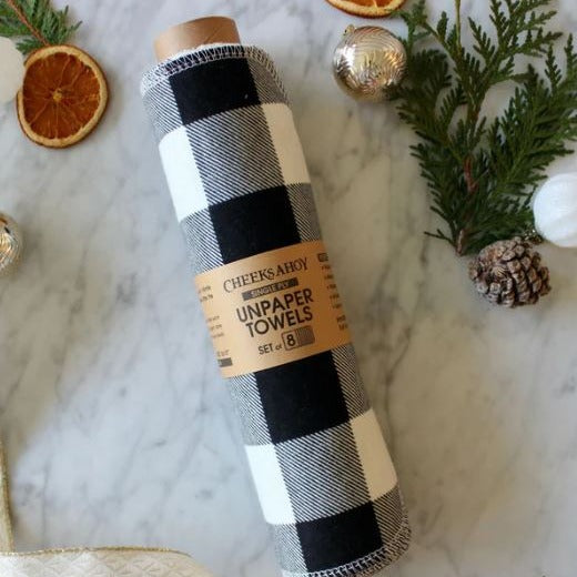 Close-up of black and white plaid fabric edges showing textured terrycloth material and neatly stitched hem detail.